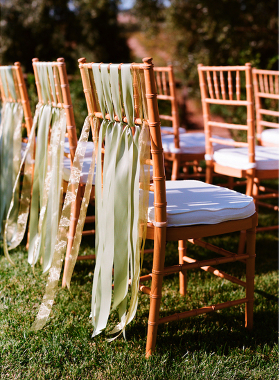 chiavari chairs with green ribbon sashes Photo credit Lisa Lefkowitz via